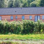 Larch clad cottage with grey uPVC windows & doors